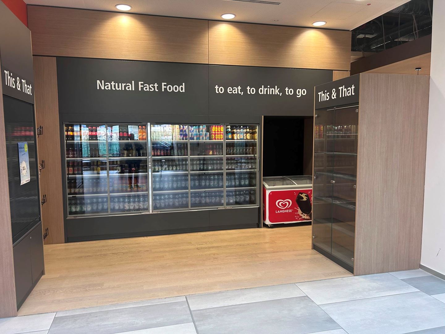 Interior of a supermarket with English signs above the shelves of products