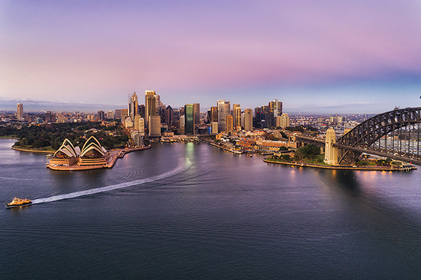 View of Sydney skyline with Sydney Opera House and Harbour Bridge at dusk
